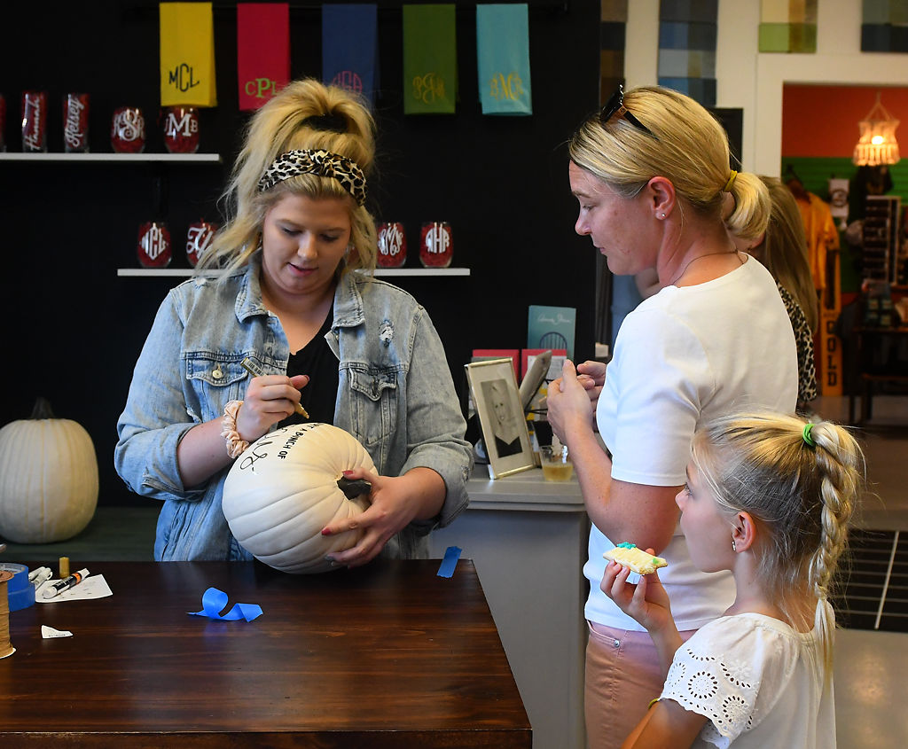 Angie Wallace and her daughter Ella Wallace, 7, talk with Morgan Cossey